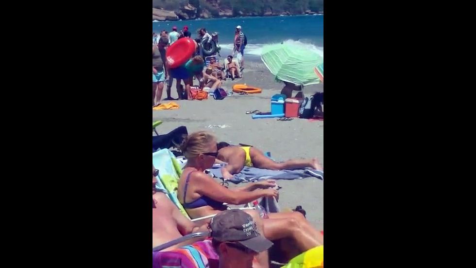 a chick jacking on a public beach